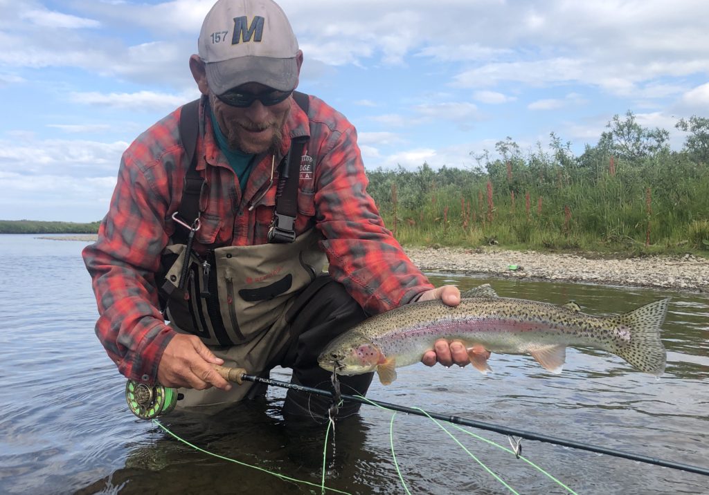 Popeye lands a beautiful rainbow trout that ate a mouse on a Beulah fly rod while in Alaska at HooDoo Lodge
