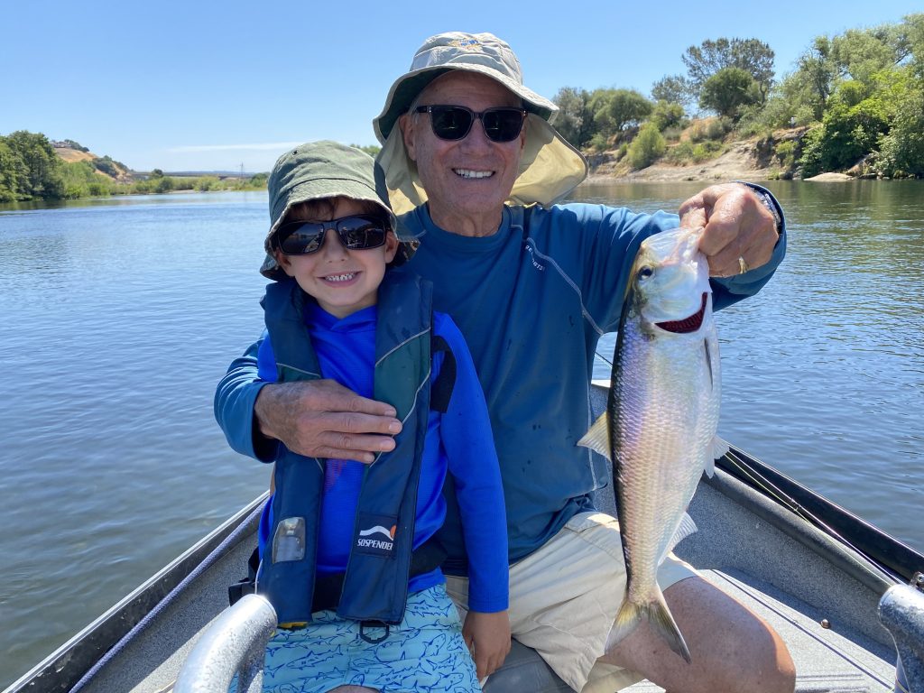 Fly Fishing for Shad on the American River Grandpa and grandson smile with Joy
