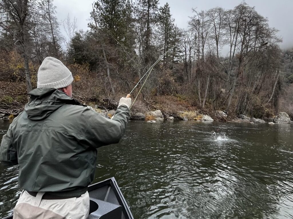 a man steelhead fishing in a boat